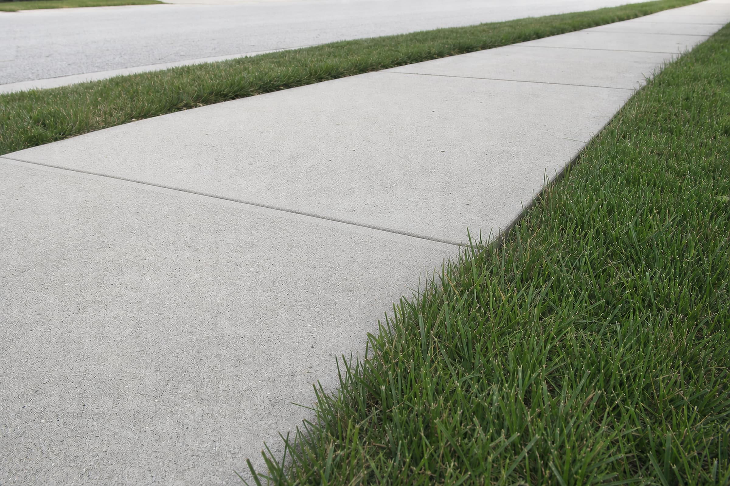 The same sidewalk leveled flush and smooth, the trip hazard gone
